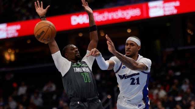 Washington Wizards center Daniel Gafford (21) passes the ball as Minnesota Timberwolves center Naz Reid (11) defends in the fourth quarter at Capital One Arena. Mandatory Credit: Geoff Burke-USA TODAY Sports